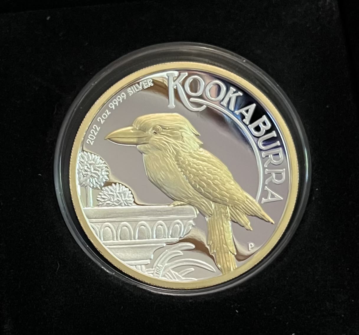 A 2022 Perth Mint 2 oz silver Kookaburra proof coin with a gold-gilded kookaburra